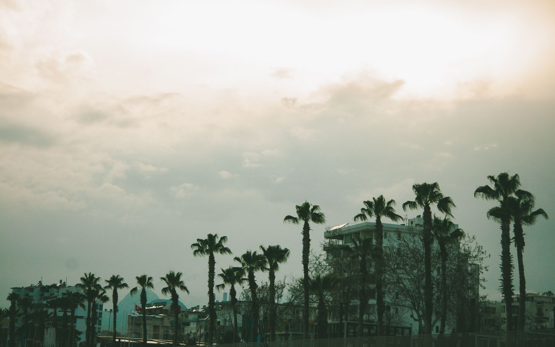 What is the difference between taking an ordinary airport taxi and booking a private transfer at Antalya Airport?